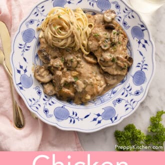 Chicken marsala on a blue and white plate on a white marble counter
