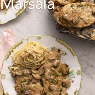 Chicken marsala on a plate on a white marble counter