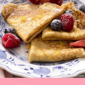 Pinterest graphic of folded crepes on a plate with berries.