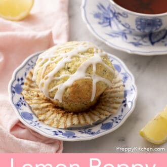Pinterest graphic of a lemon poppy seed muffin unwrapped on a blue and white plate alongside a cup of tea and decorative lemon wedges.