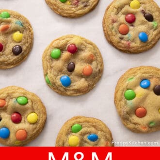 Pinterest graphic of M&M cookies arranged on a sheet of parchment paper.