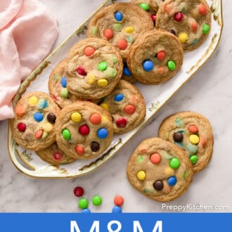 Pinterest graphic of several M&M Cookies on a floral serving tray. Two on the side.