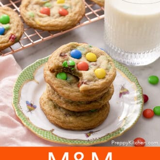 Pinterest graphic of a stack of M&M Cookies on a plate with a green border. Milk and more cookies in the background.