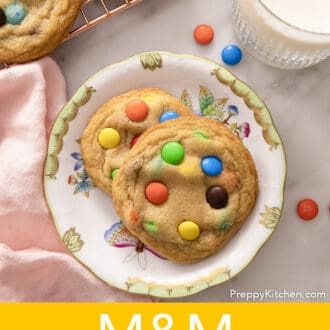 Pinterest graphic of two M&M Cookies on a floral plate.