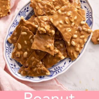 Pinterest graphic of pieces of peanut brittle piled on a blue and white platter.