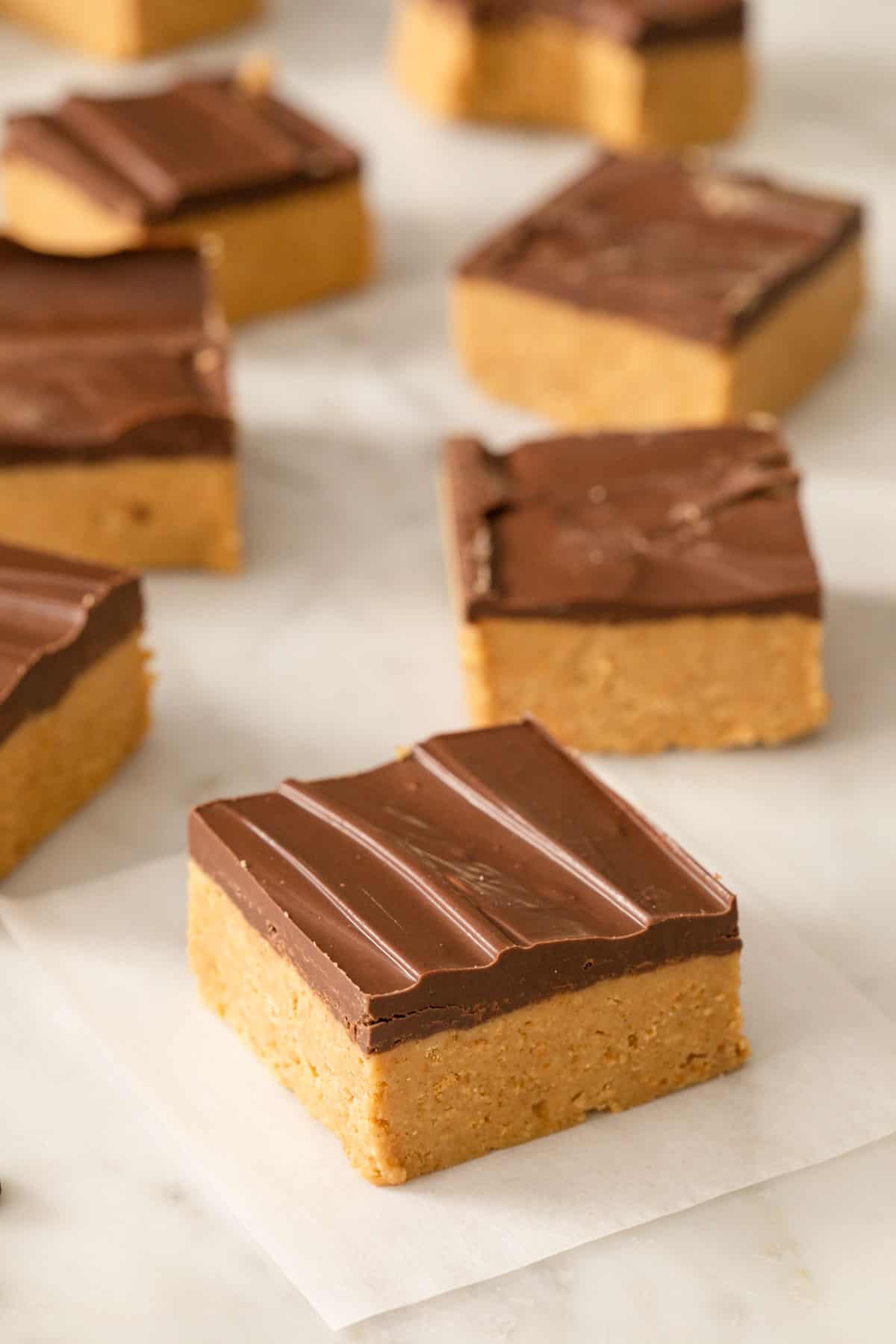 Peanut butter bars on a marble work surface.
