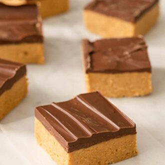 A Pinterest graphic showing peanut butter bars on a marble countertop.