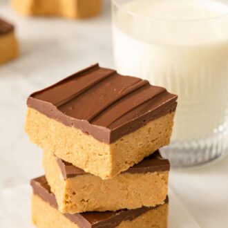 A Pinterest graphic showing a stack of peanut butter bars with a glass of milk.