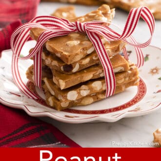 Pinterest graphic of pieces of peanut brittle stacked on a christmas plate.