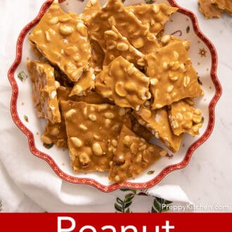 Pinterest graphic of an overhead view of pieces of peanut brittle stacked on a christmas plate.