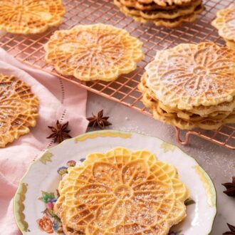 A pinterest graphic of Pizzelle cookies in a plate and some in the background on a cooling rack.