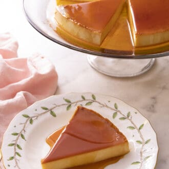Pinterest graphic of a slice of flan on a porcelain plate in front of the rest of the dessert.