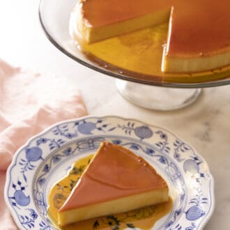 Pinterest graphic of a piece of flan on a blue and white plate with the rest of the flan in the background.