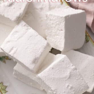 Pinterest graphic of an overhead view of cubed homemade marshmallows on a platter.