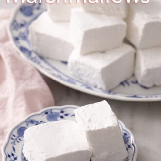 Pinterest graphic of two cubes of marshmallows on a blue and white plate.