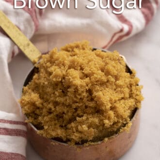 Pinterest graphic of brown sugar in a copper measuring cup.