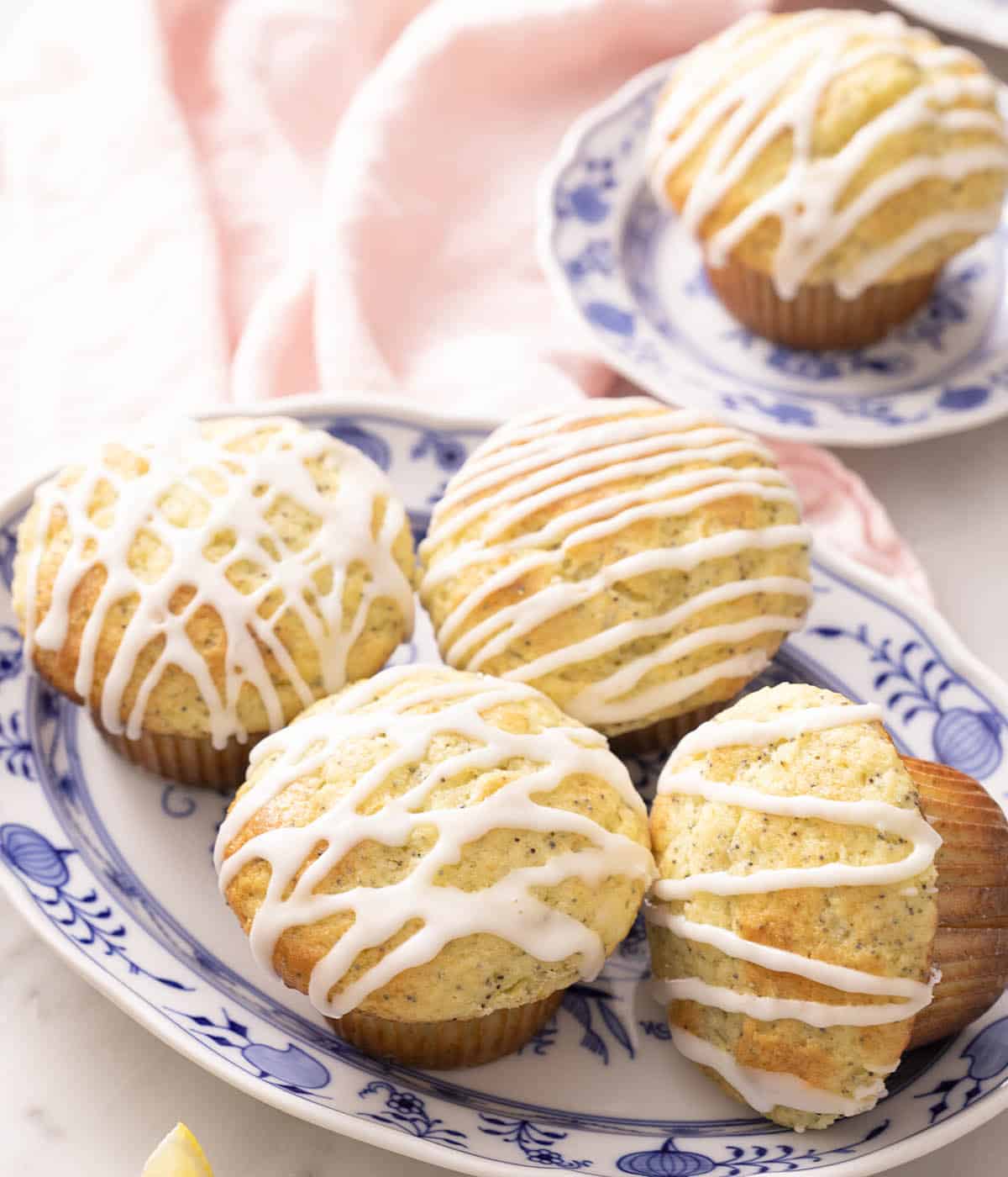 Five lemon poppy seed muffins with a delicious lemon drizzle.