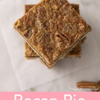 Pinterest graphic of a top down shot of pecan pie bars stacked on a piece of parchment.