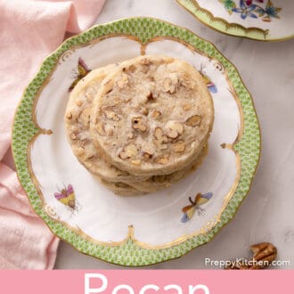 pecan sandies stacked on a plate with a cup of tea