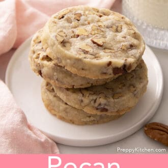 pecan sandies stacked on a white plate