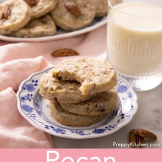 pecan sandies stacked on a blue and white plate