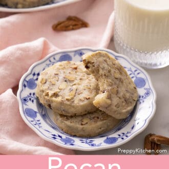 pecan sandies stacked on a blue and white plate