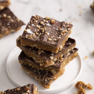 pieces of toffee stacked on a white plate