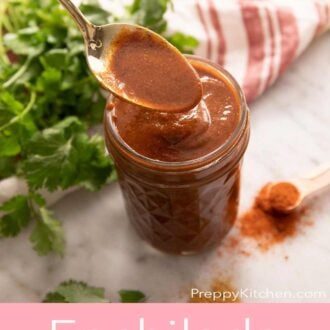 Pinterest graphic showing homemade enchilada sauce in a jar with fresh cilantro and a striped linen cloth on the side.