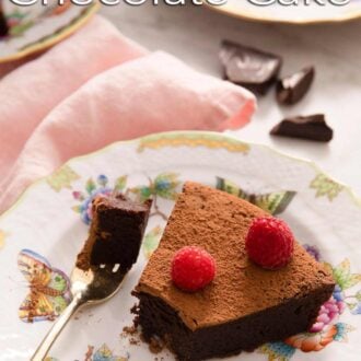A pinterest graphic of a slice of flourless chocolate cake with a bite taken out.