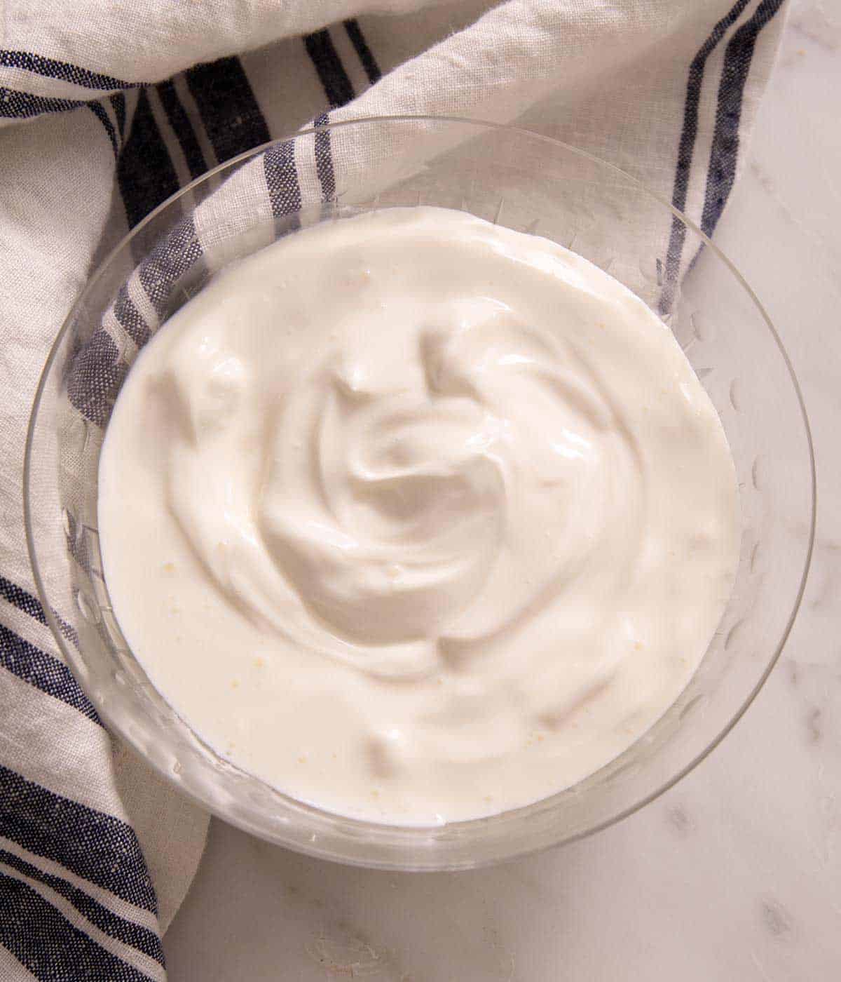 An overhead shot of homemade sour cream in a bowl.