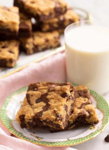 Two brookies on a plate with a glass of milk in the background
