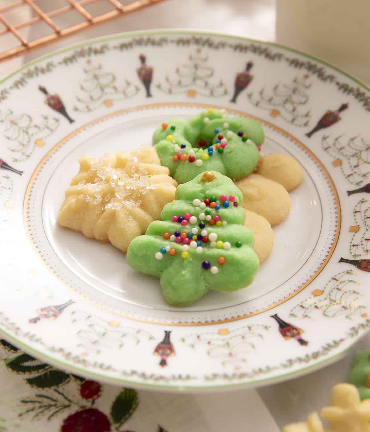 Cookies in the shape of christmas trees and flowers on a plate