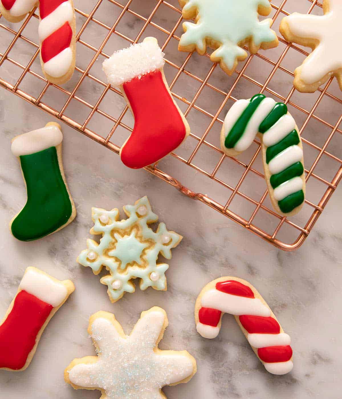 An overhead shot of different festive cookies with colored sugar cookie icing