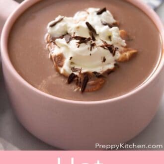 A pinterest graphic of a pink mug of hot chocolate.