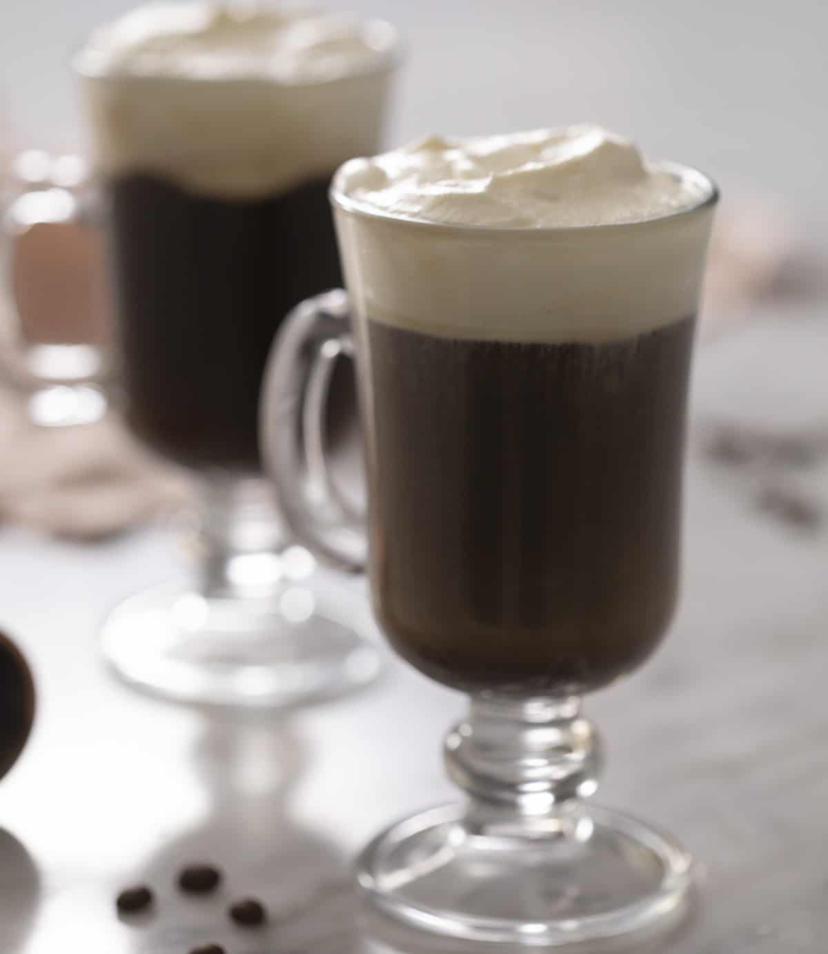 A close up of an Irish coffee in a glass mug