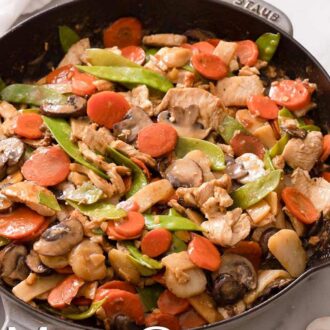 Pinterest graphic of a skillet of moo goo gai pan.