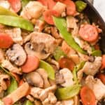 A close up view of moo goo gai pan in a skillet.
