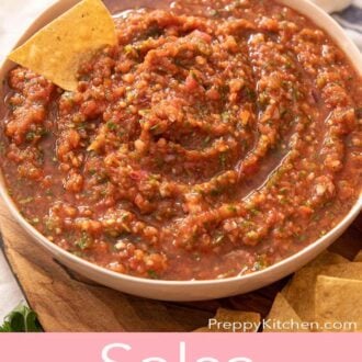 A Pinterest graphic of homemade salsa with a chip tucked in.