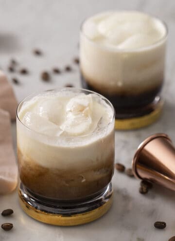 Two White Russian cocktails on a marble surface