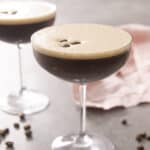 A close up of an espresso martini with another in the background.
