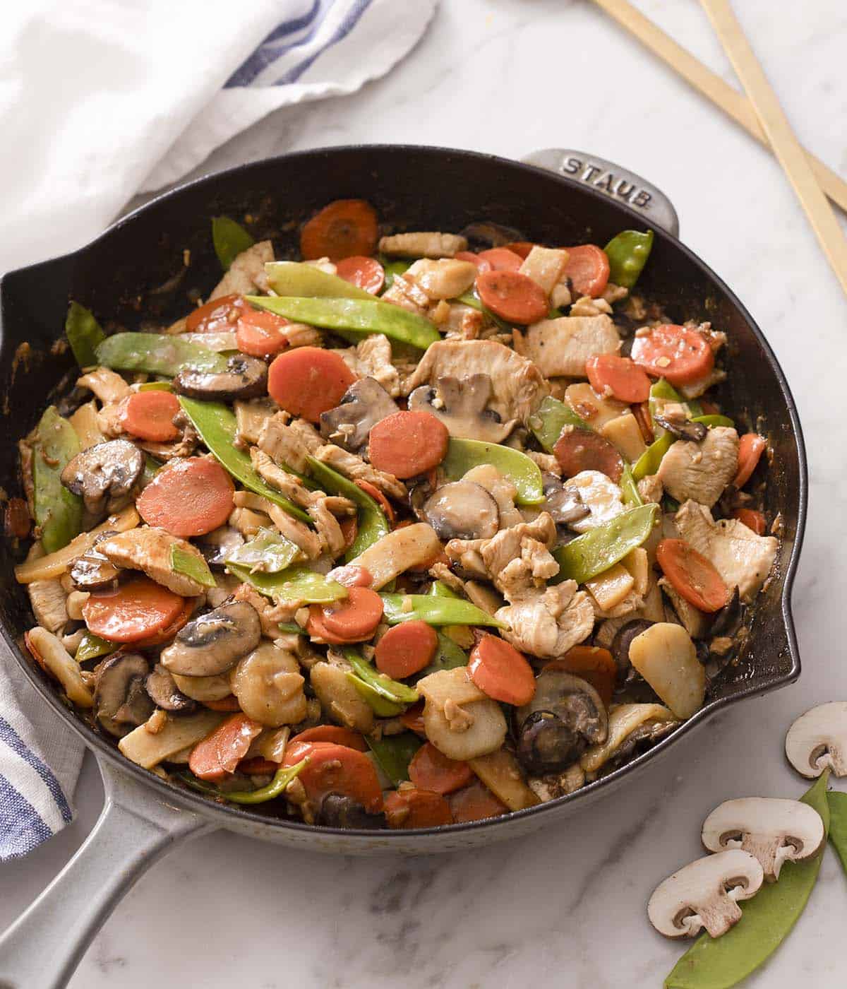 A cast iron skillet with moo goo gai pan.
