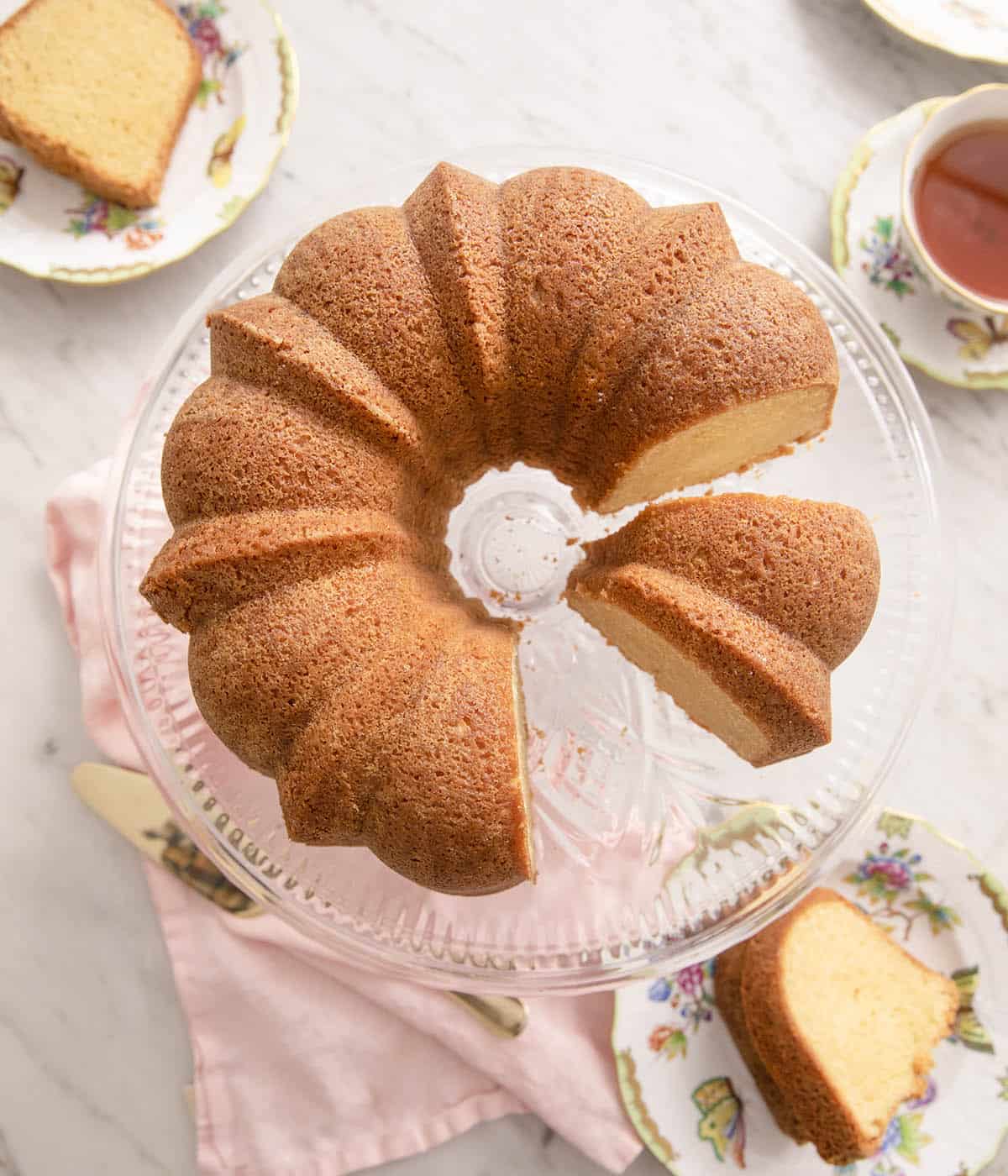 An overhead shot of sour cream pound cake with slices cut out.