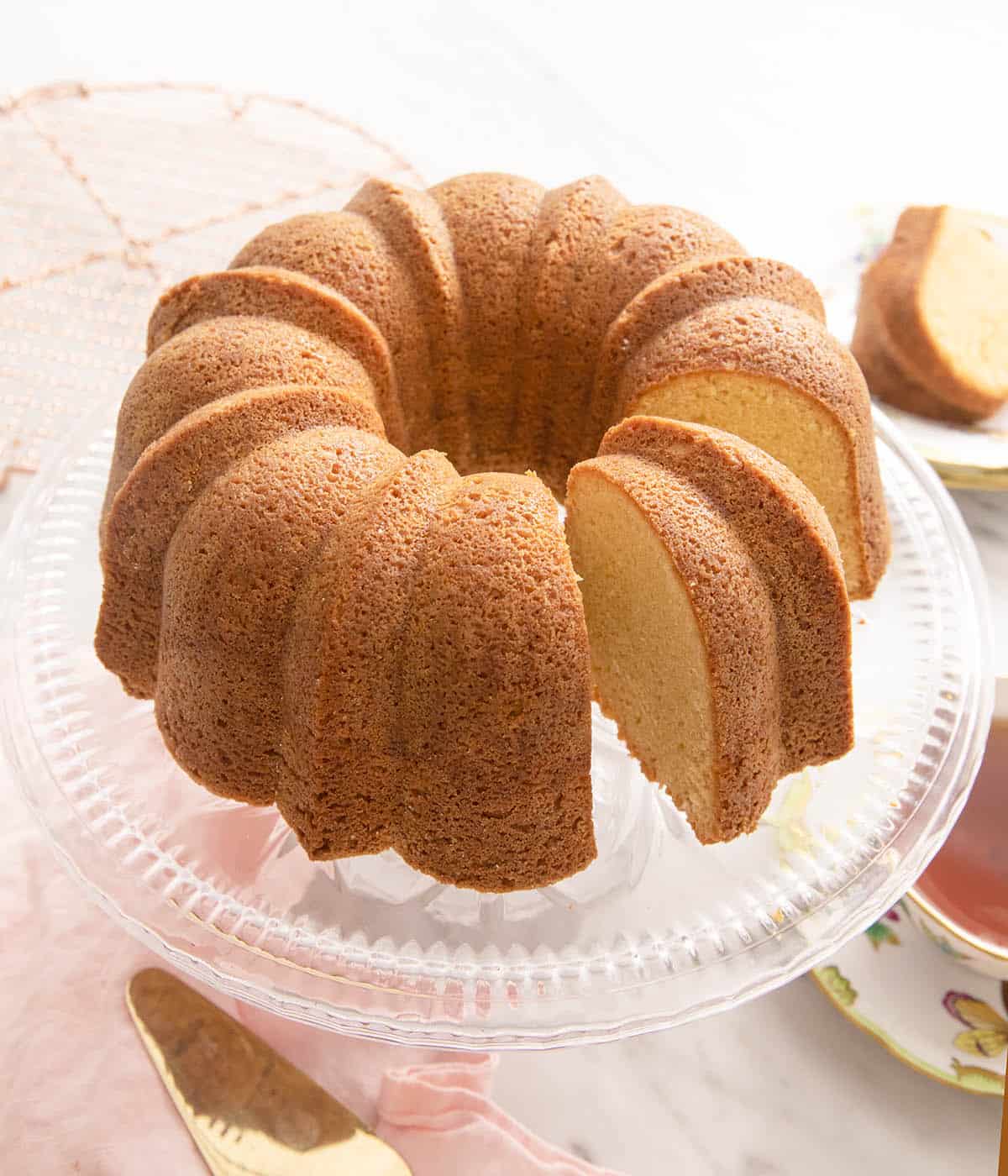 A sour cream pound cake on a cake stand.
