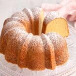 A close up of the sour cream pound cake with a slice cut out.
