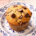 A close up of banana chocolate chip muffin on a plate.