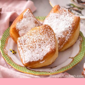 Pinterest graphic of beignets on a patterned plate.