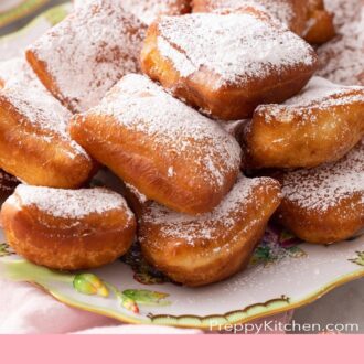 Pinterest graphic of a pile of beignets on a platter.