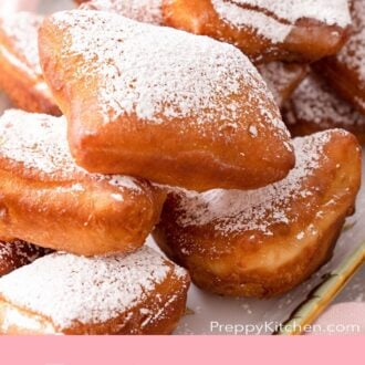 Pinterest graphic of a close-up of a platter of homemade beignets.