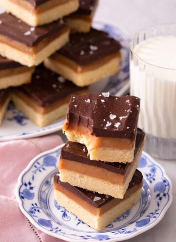Three Millionaire's shortbread stacked on top of each other one with a bite out