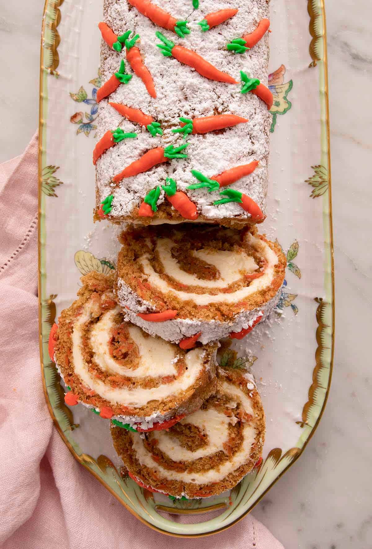 An overhead shot of a a carrot cake roll cut into slices